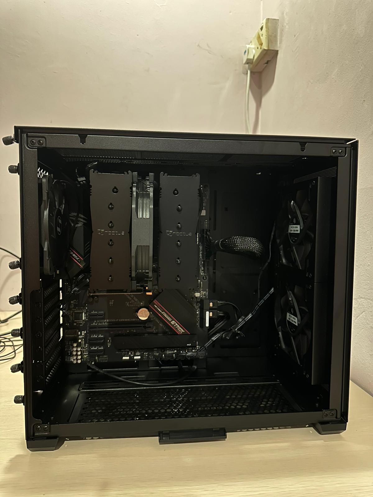 The side of the case with its internals exposed. The motherboard is visible with many wires coming from it to other components.